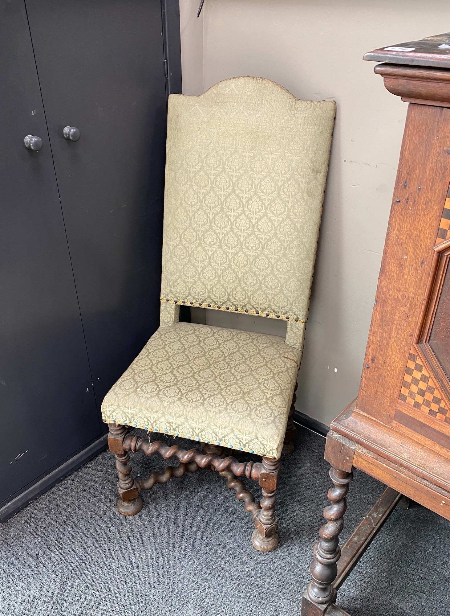 A pair of late 17th century walnut hall chairs with upholstered backs and seats on barley twist underframes, width 48cm, height 118cm